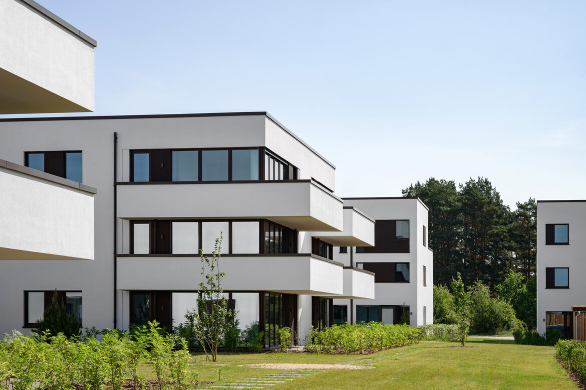 Facde of a contemporary residential building with projecting balconies and floor-to-ceiling glazing