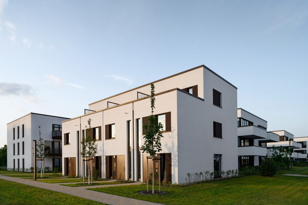 Residential façade illuminated in the evening against a blue twilight sky